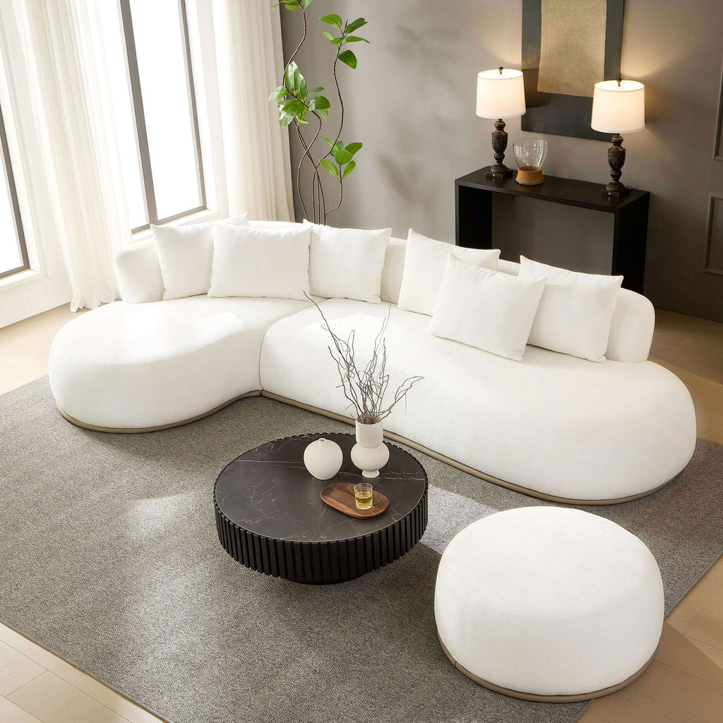 Beige oversized L-shape sectional sofa with ottoman styled in a modern living room, offering spacious seating and soft, cozy cushions.
