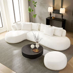 Beige oversized L-shape sectional sofa with ottoman styled in a modern living room, offering spacious seating and soft, cozy cushions.