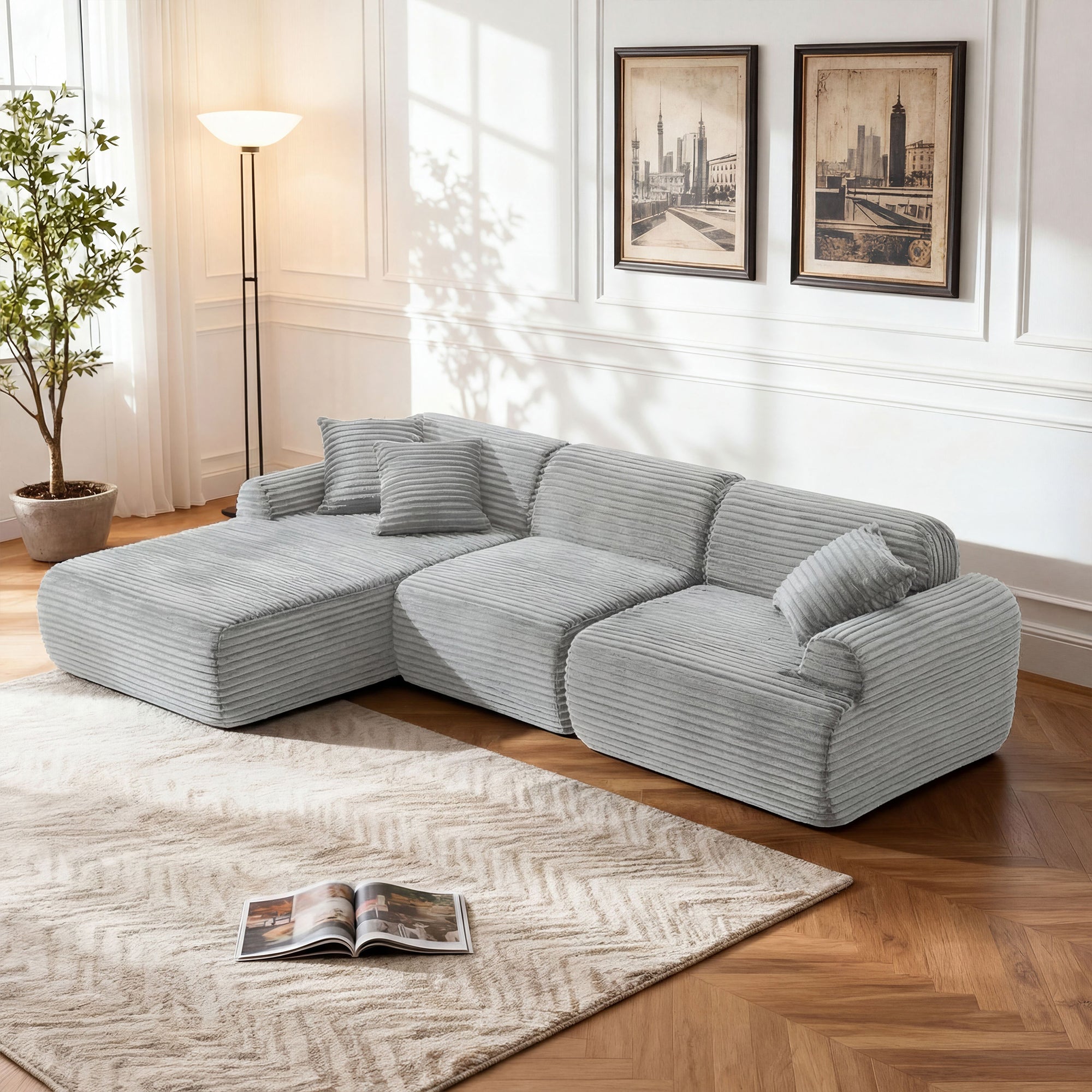 Modern light gray modular sectional sofa in textured corduroy fabric, featuring a low-profile, L-shaped lounge design.