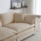 Close-up of beige chenille sectional sofa corner with soft back and side pillows. Breathable fabric enhances comfort and modern appeal.