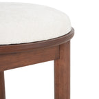 Close-up of beige dining chair seat cushion and wood frame. Highlights plush fabric and fine craftsmanship.