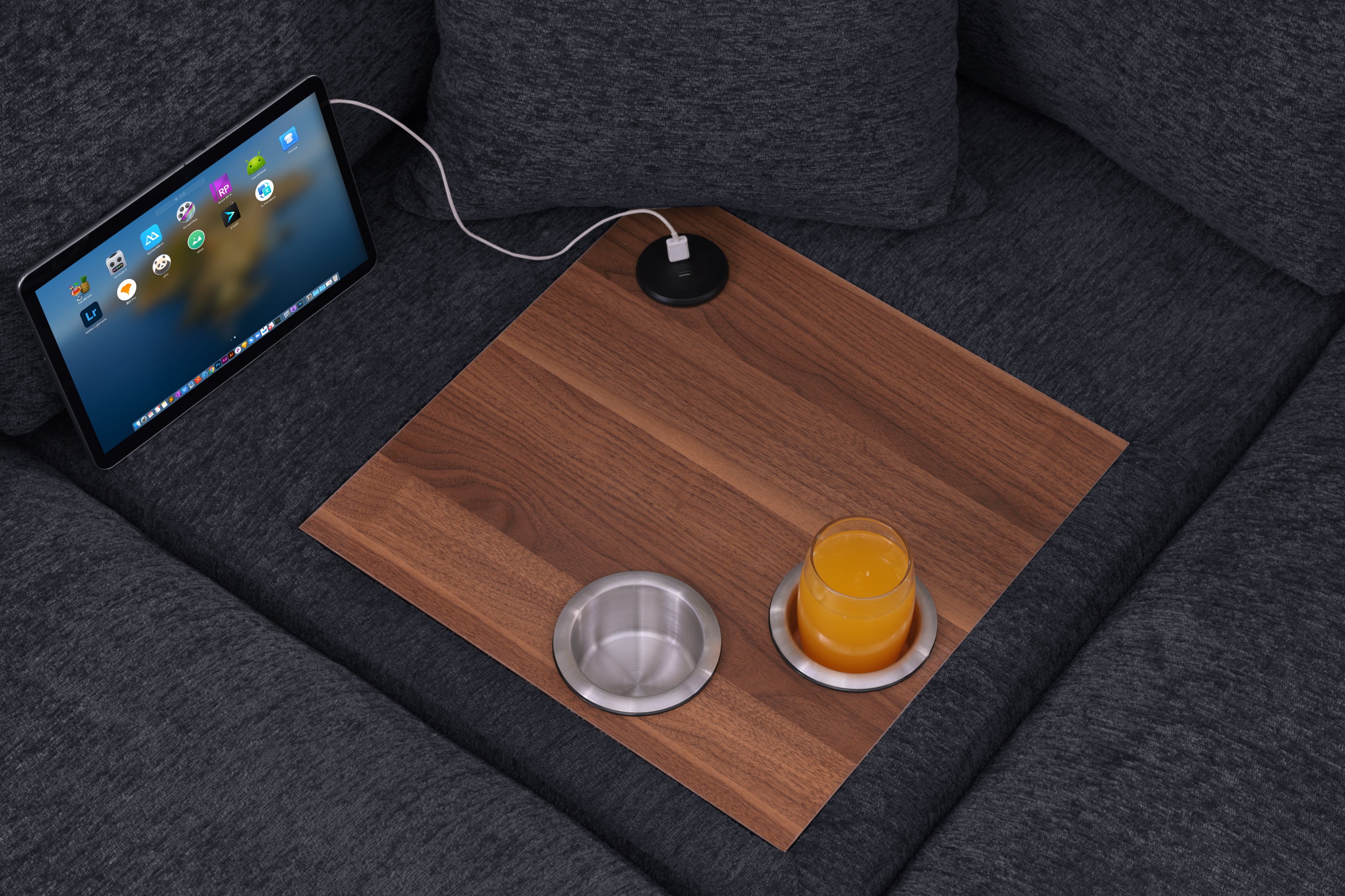 Close-up of Celine Corner Sofa's built-in wood tray with USB charging port, cupholders, and tablet for modern convenience.