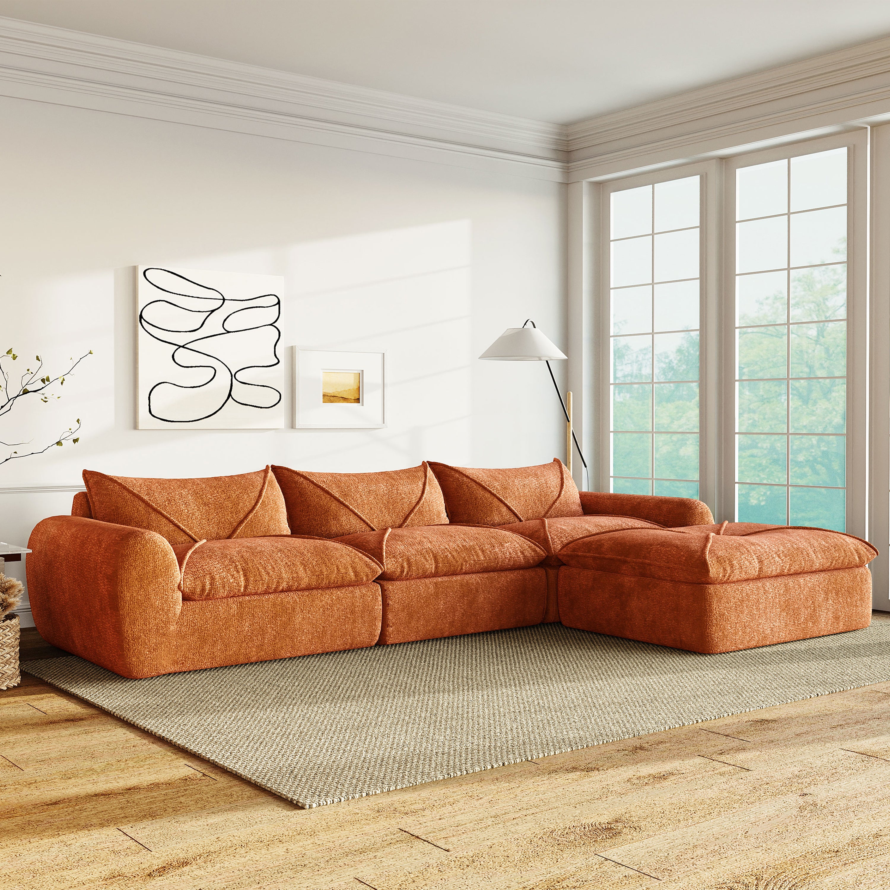 116'' compressed sofa no assembly in burnt orange chenille, placed in a modern living room with natural light and wood flooring.