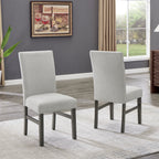Pair of upholstered dining chairs from Selena Dining Set in light gray fabric with dark wood legs, ideal for modern interiors.