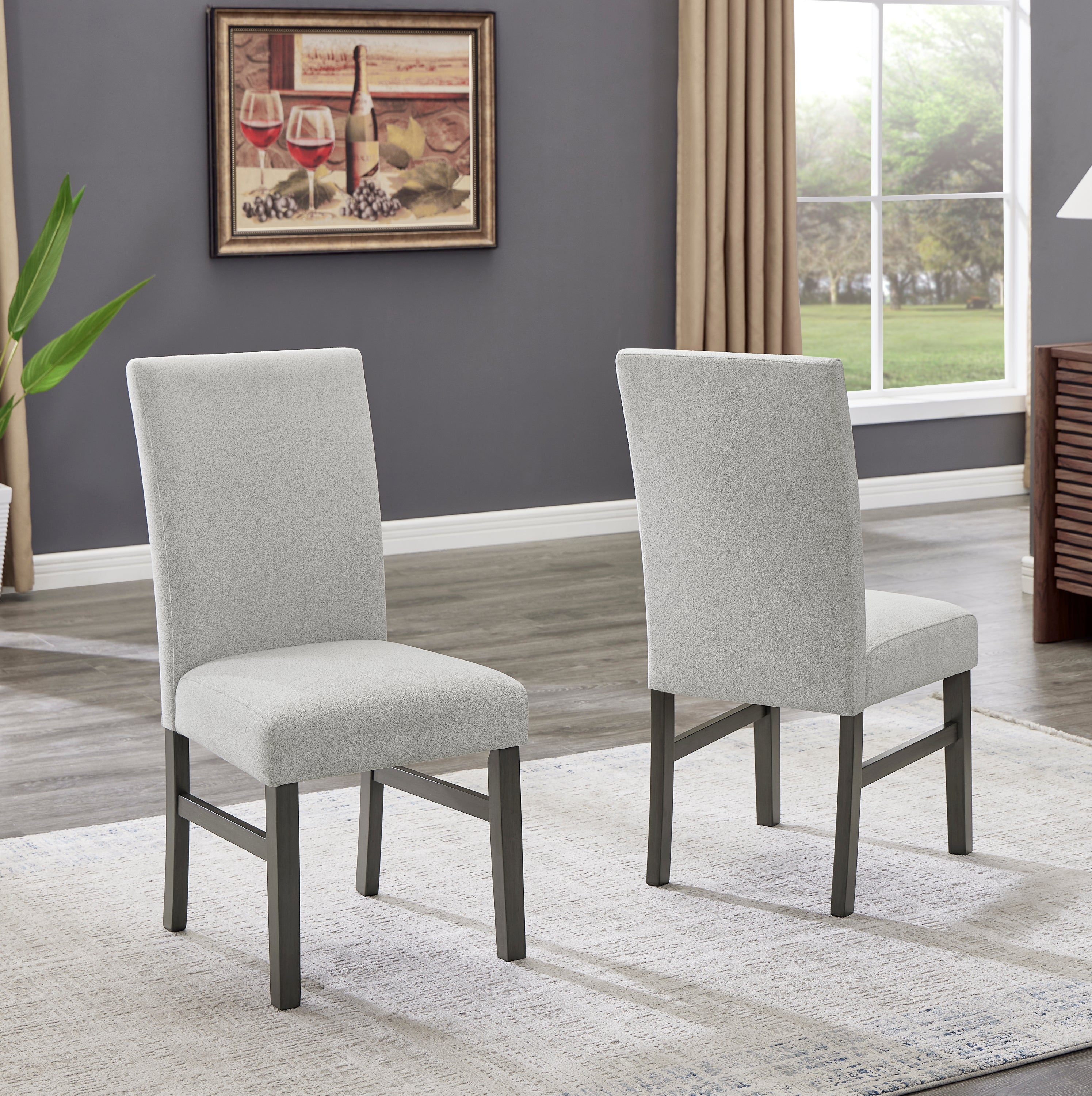 Pair of upholstered dining chairs from Selena Dining Set in light gray fabric with dark wood legs, ideal for modern interiors.