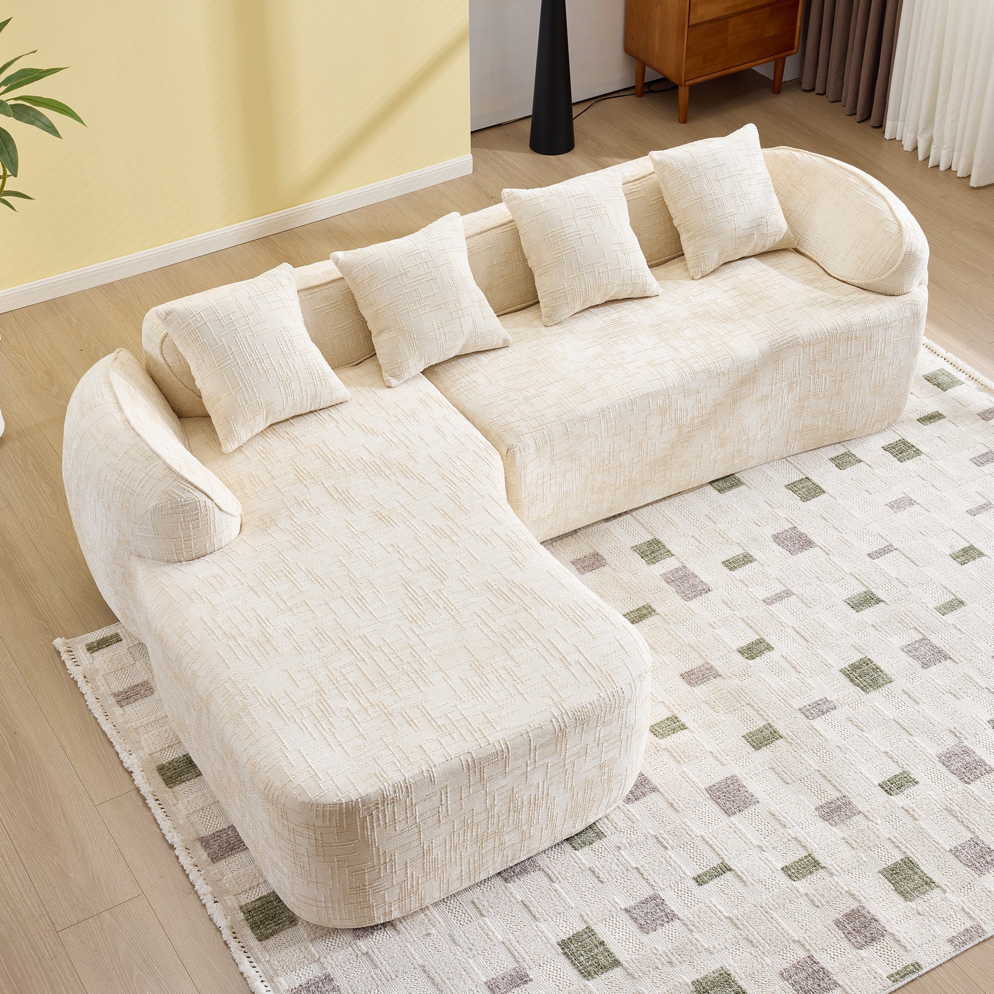 Top view of L-shaped beige chenille sofa with five pillows, showcasing its spacious and ergonomic design.