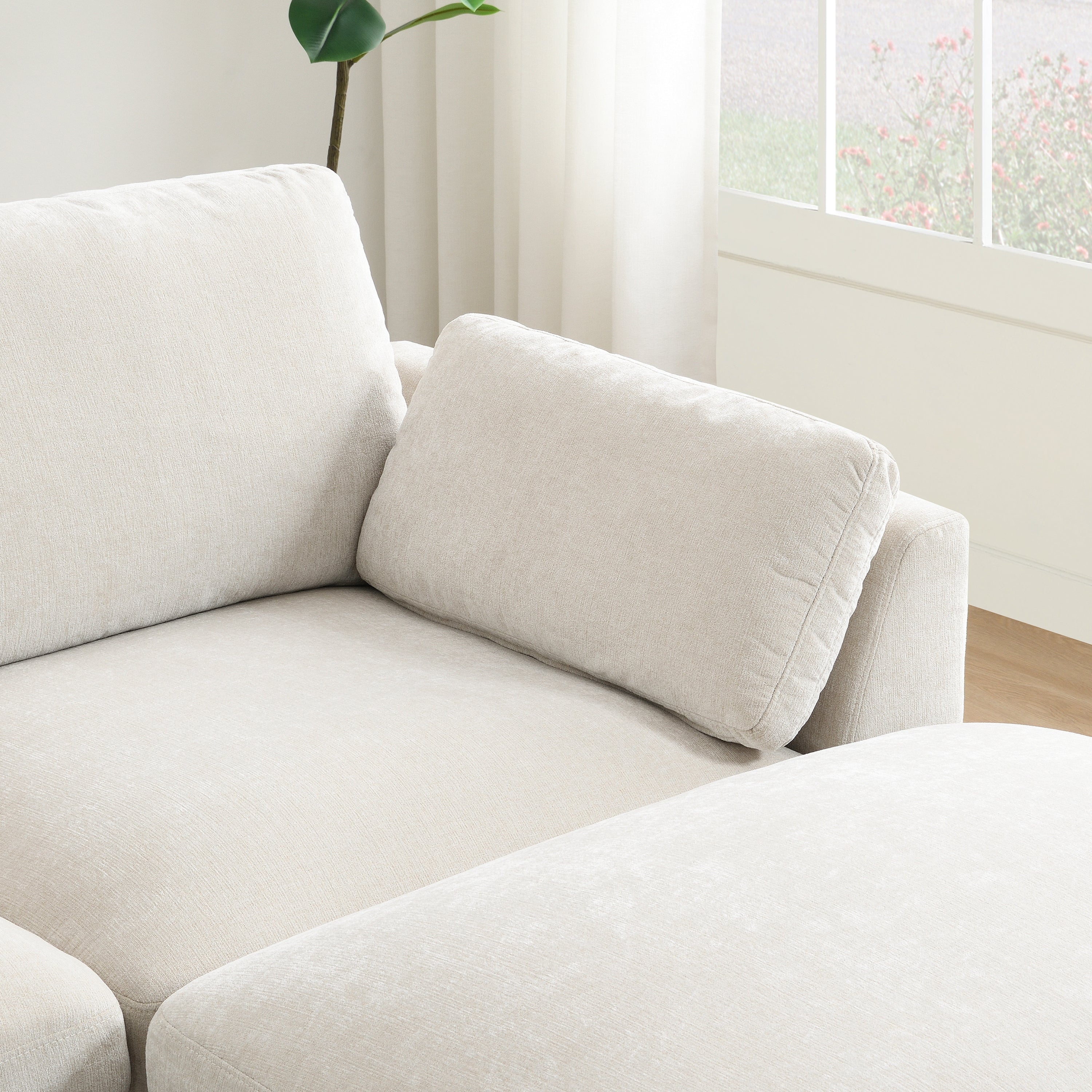 Lumbar cushion placed on the chaise section of the modular sectional sofa for added back support.