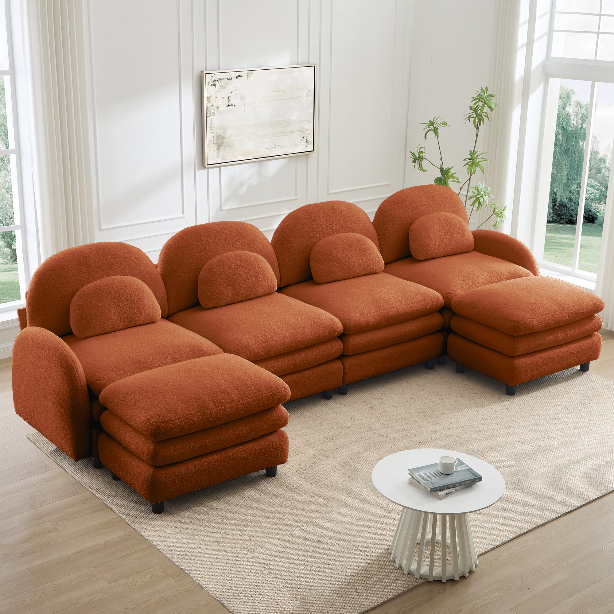 Orange 4-seater modular teddy fabric sectional sofa with curved backrests, lumbar pillows, and two movable ottomans.