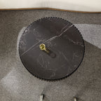 Overhead view of the 35.43'' modern round coffee table with black sintered stone top, placed on a textured gray carpet.