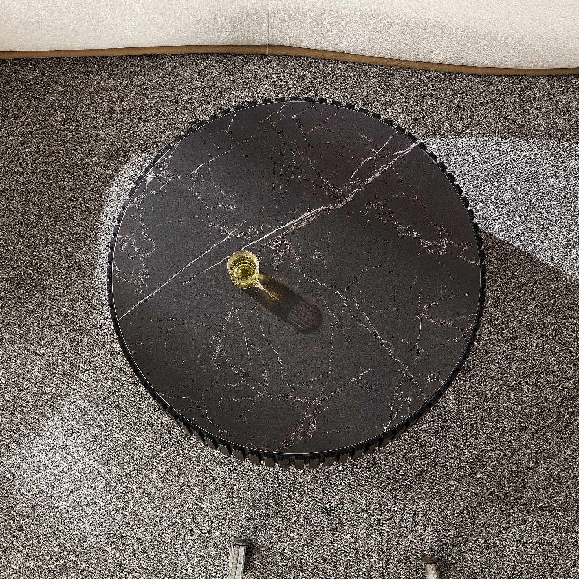 Overhead view of the 35.43'' modern round coffee table with black sintered stone top, placed on a textured gray carpet.