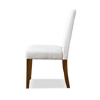 Side profile of rustic upholstered dining chair with white fabric and brown wood legs, designed for comfort and style.