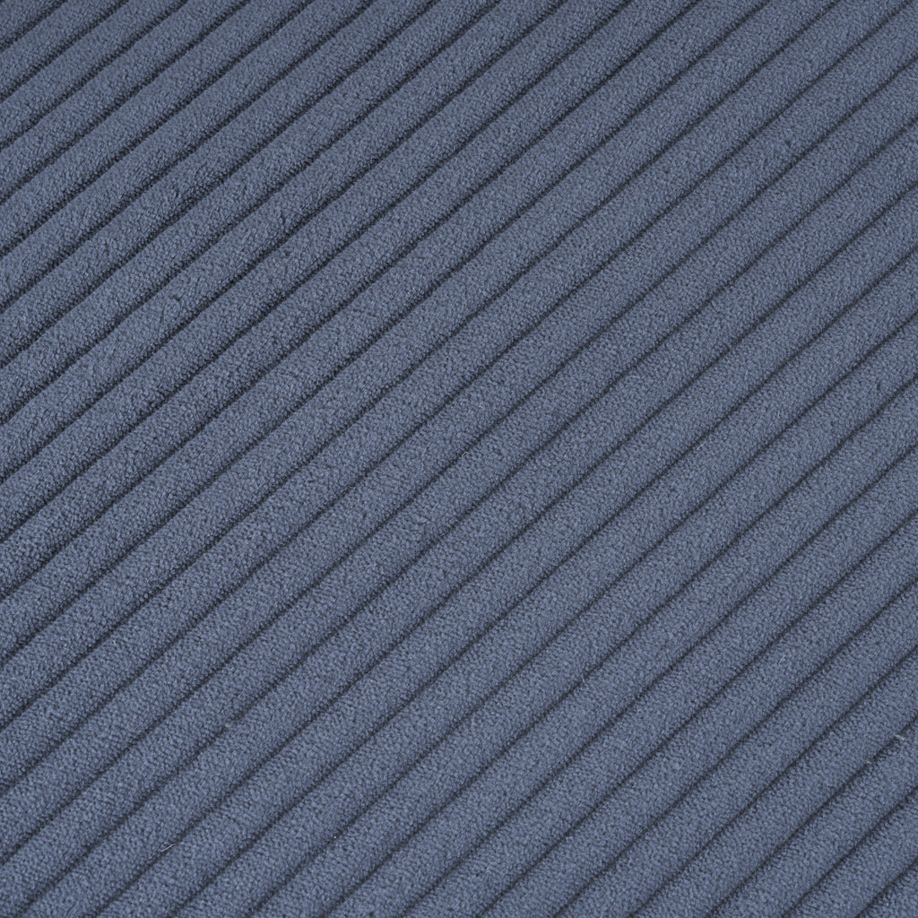 Close-up of blue corduroy fabric texture on the modular sofa. Soft ribbed material enhances comfort and adds a modern touch to living spaces.