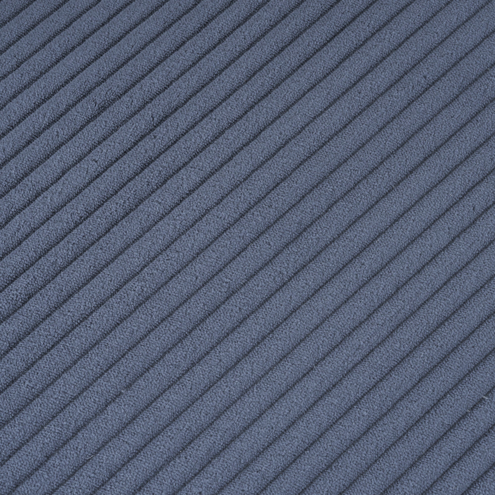Close-up of blue corduroy fabric texture on the modular sofa. Soft ribbed material enhances comfort and adds a modern touch to living spaces.