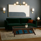 Mid-Century Modern Coffee Table in Morocco Brown placed in a moody modern living room with dark green sofa and geometric wall art.