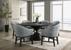 Haven 7Pc Dining Set - Round Ebony features a 59-inch black wood table with modern cone base and six gray barrel chairs in a contemporary dining room.