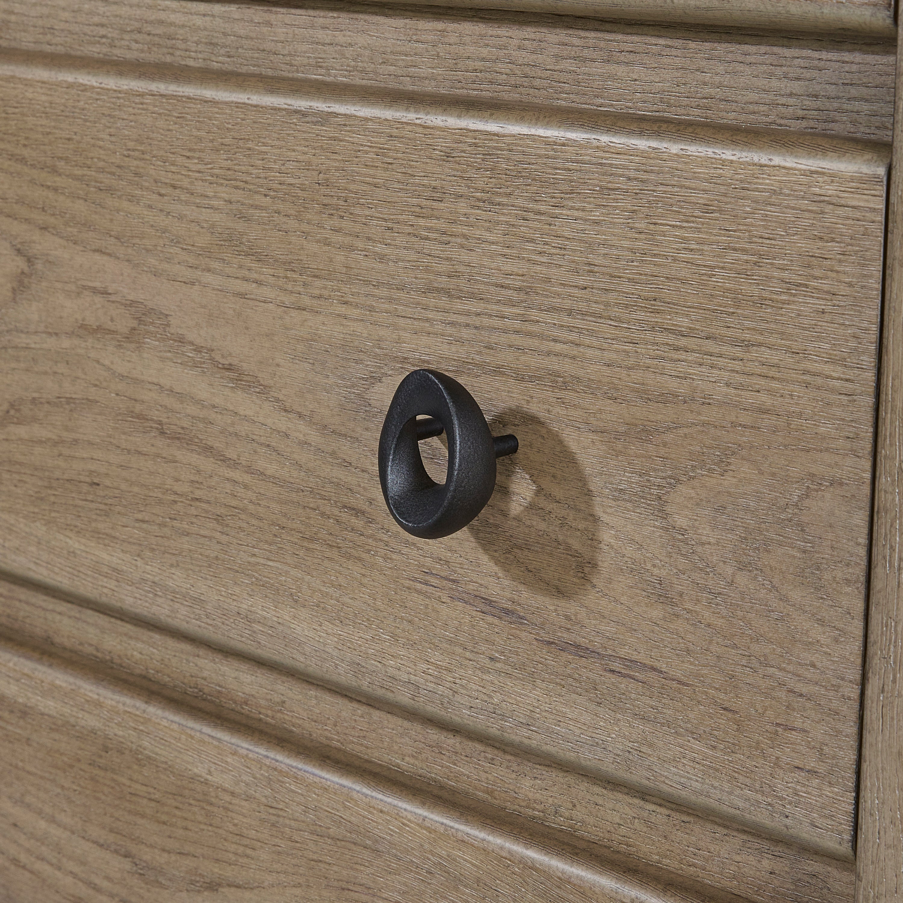 Close-up of English Knotty Oak Dresser drawer showing textured wood grain and modern black metal knob for a rustic-modern look.