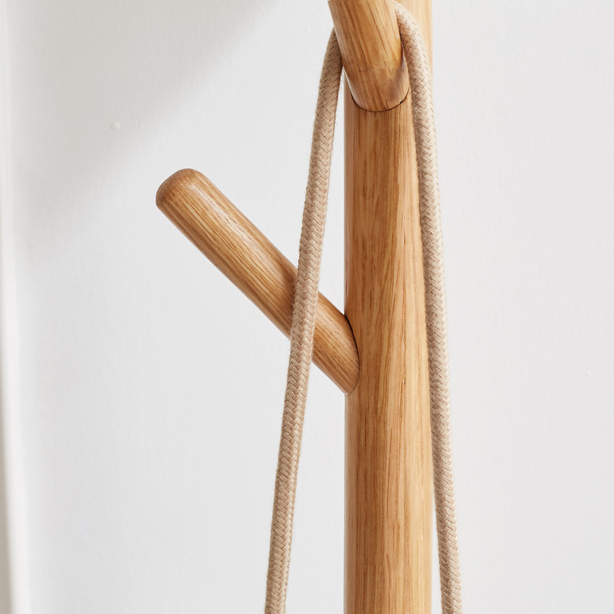 Close-up of oak coat hanger pegs on Solid Wood Shoe Stool, highlighting smooth craftsmanship and natural wood grain texture.