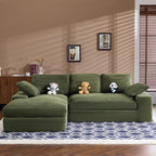 Green corduroy sofa with plush cushions and pillows, styled with stuffed toys. Compact and stylish for modern home interiors.