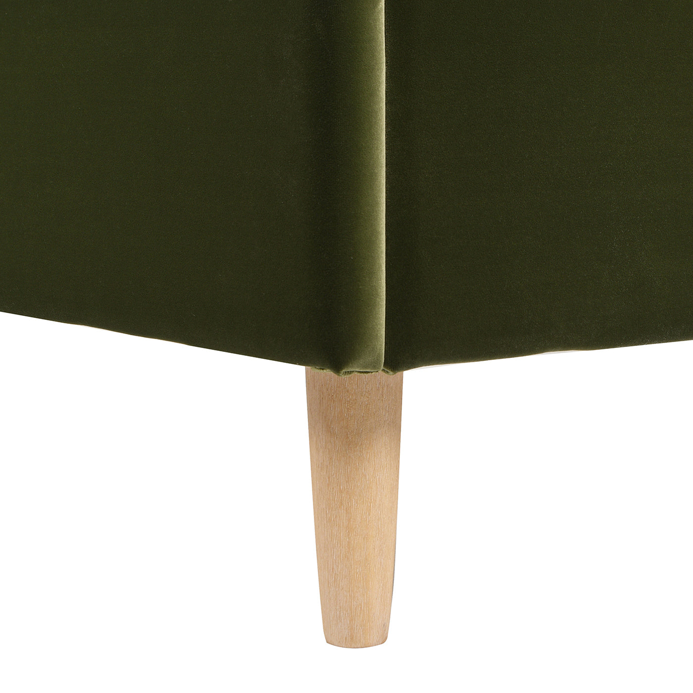 Detail of the olive green velvet corner and tapered wooden leg of the Stockholm Modern Wavy Headboard Platform Bed, queen size.
