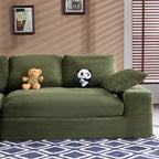 Green corduroy sofa with foam-filled cushions and pillows, placed in a cozy room with wall art and wooden blinds for a warm ambiance.