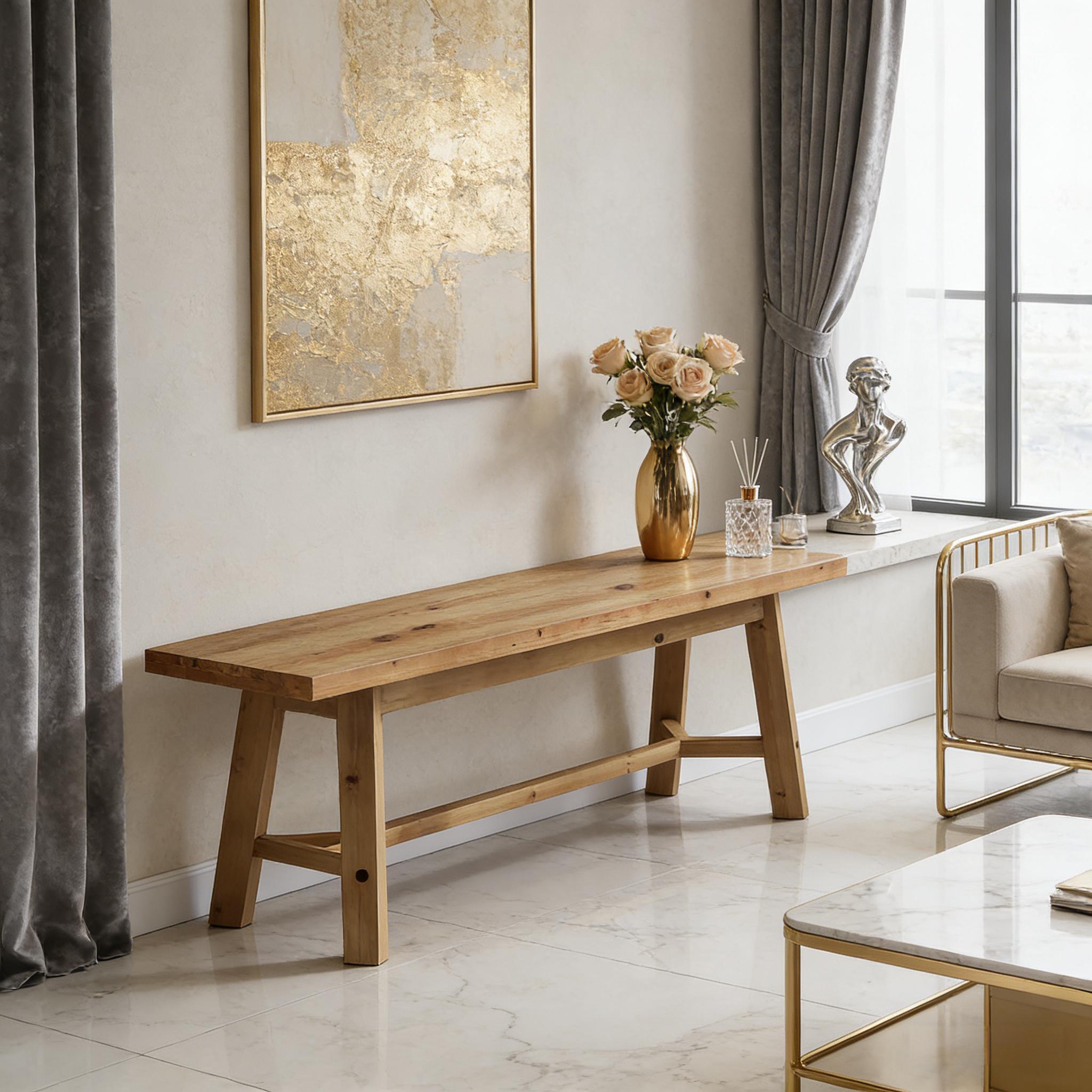 Modern farmhouse wooden bench with a natural finish, clean lines, and sturdy trestle base in a bright living space.