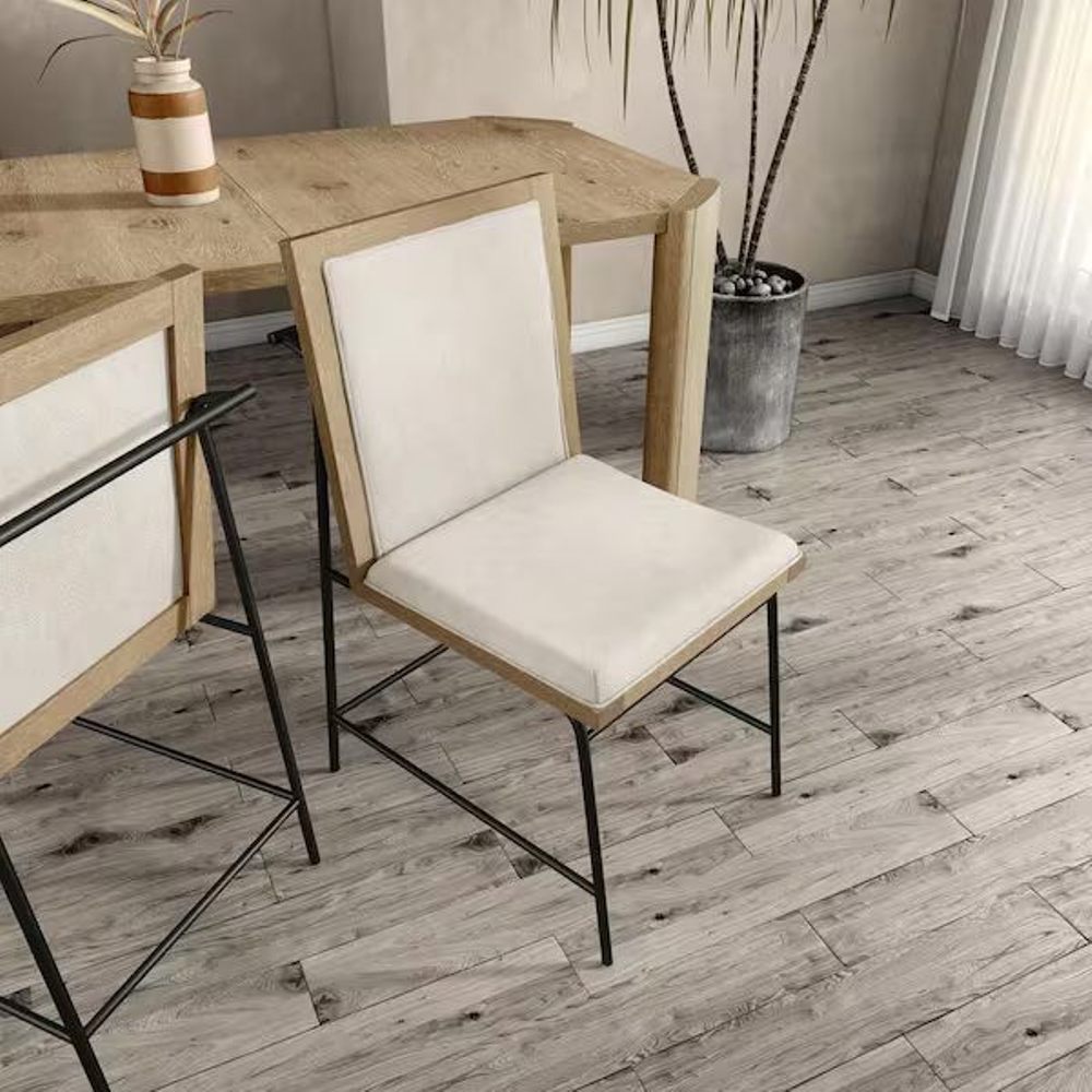 Angled view of Oak Beige Dining Chair showcasing its modern design with beige upholstery, wood frame, and black metal legs.