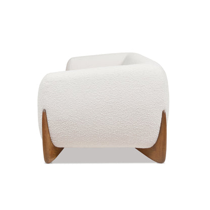 Side profile of Alpine Sherpa Sofa Ivory White displaying curved armrest and oak wood leg for a sculptural furniture silhouette.