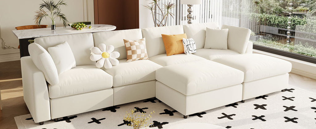 Angled view of U_STYLE U-shaped sectional sofa with 2 ottomans, placed in a bright room with large windows and modern decor.