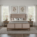 Arcadia king size bed in Old Forest Glen finish with a beige upholstered, paneled headboard and footboard frame.