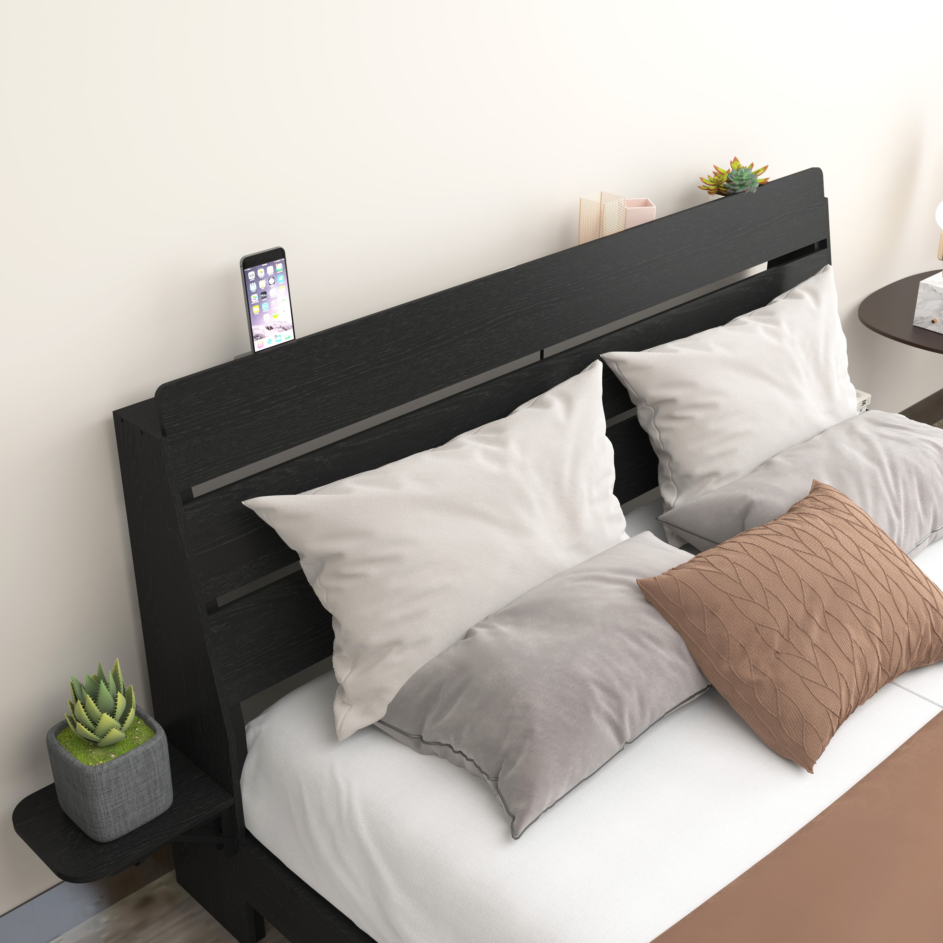 Close-up of Queen Floating Bed Frame headboard with phone slot and side shelf. Modern black wood finish with soft pillows and cushions.