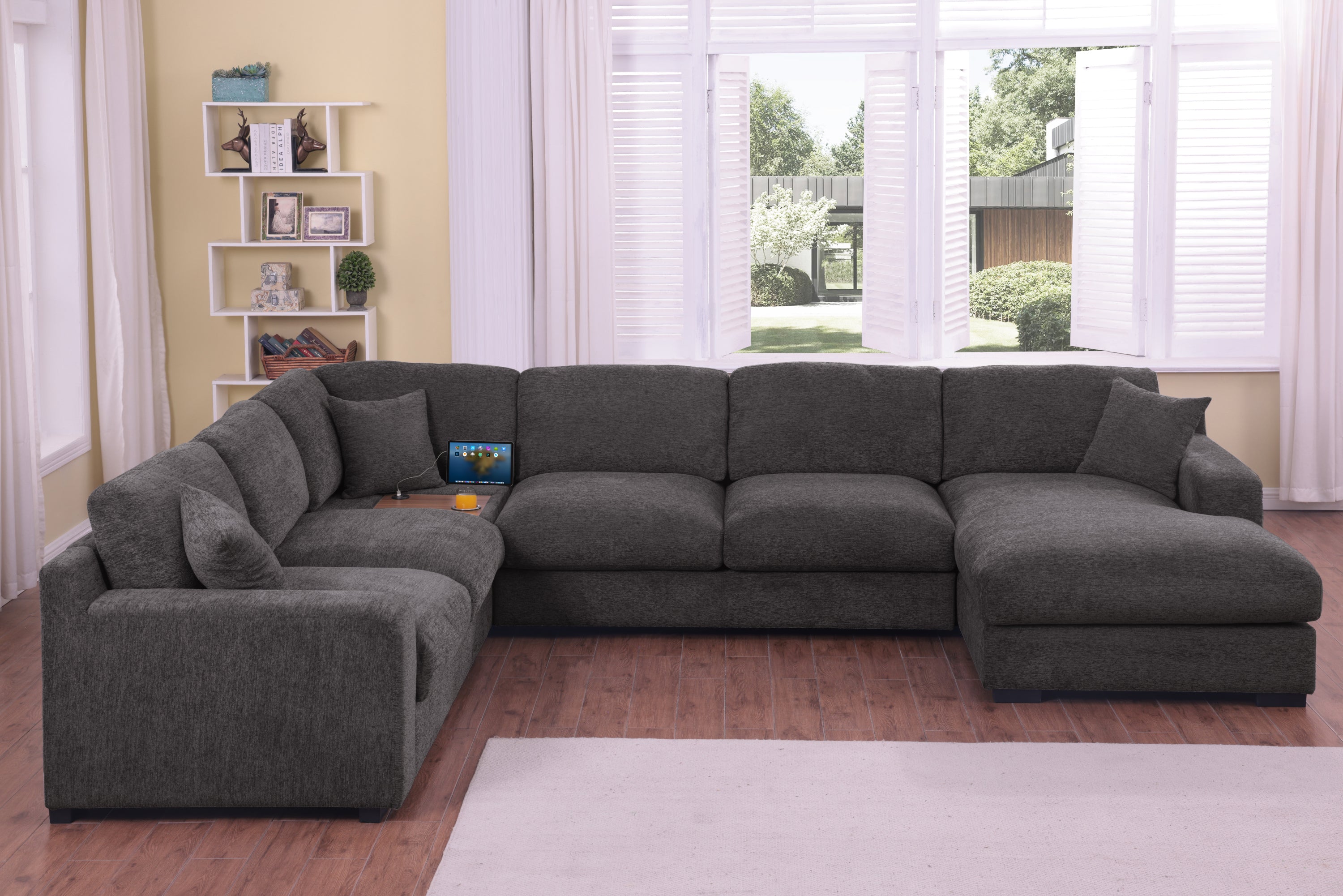Gray chenille sofa sectional with chaise lounge and tech-friendly features like cupholders and USB charging ports in a cozy interior.