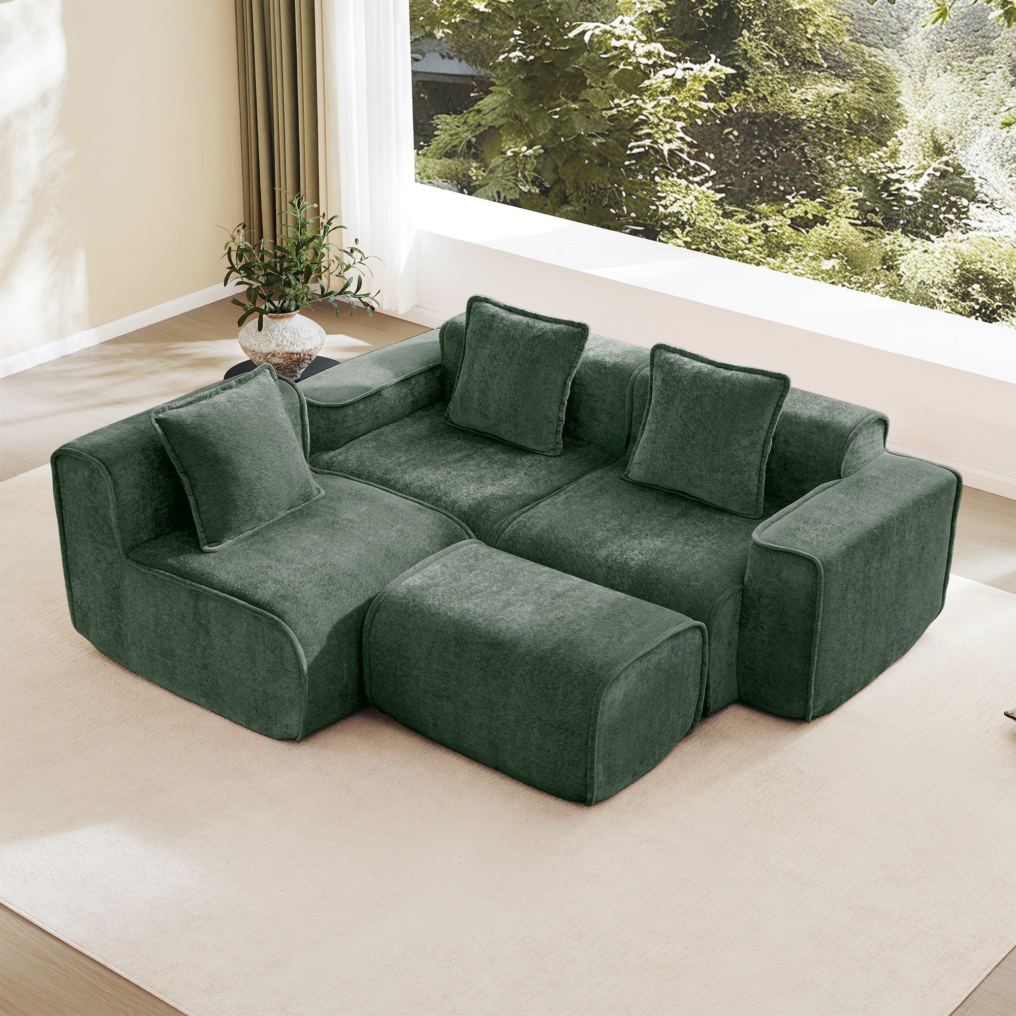L-shaped configuration of green velvet modular sofa with ottoman, showcasing flexible seating arrangement and no assembly design.