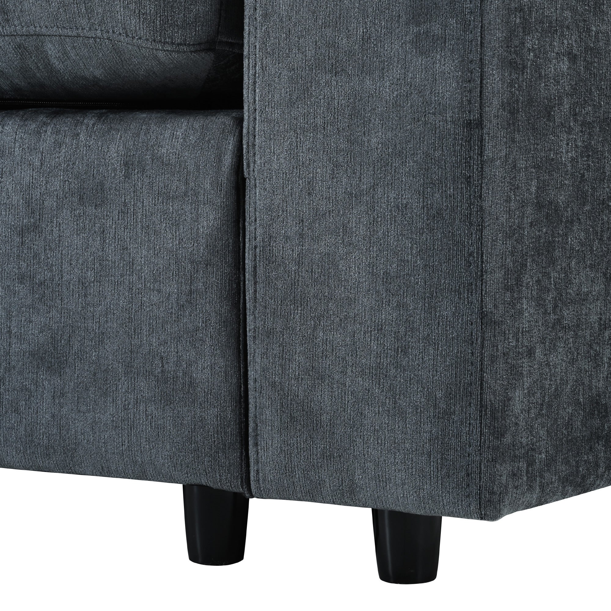 Bottom corner of modular sofa showing sturdy black legs and durable grey fabric, designed for modern living room use.