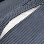 Zippered cushion cover on the blue corduroy modular sofa reveals inner padding. Easy to remove for cleaning and maintenance.