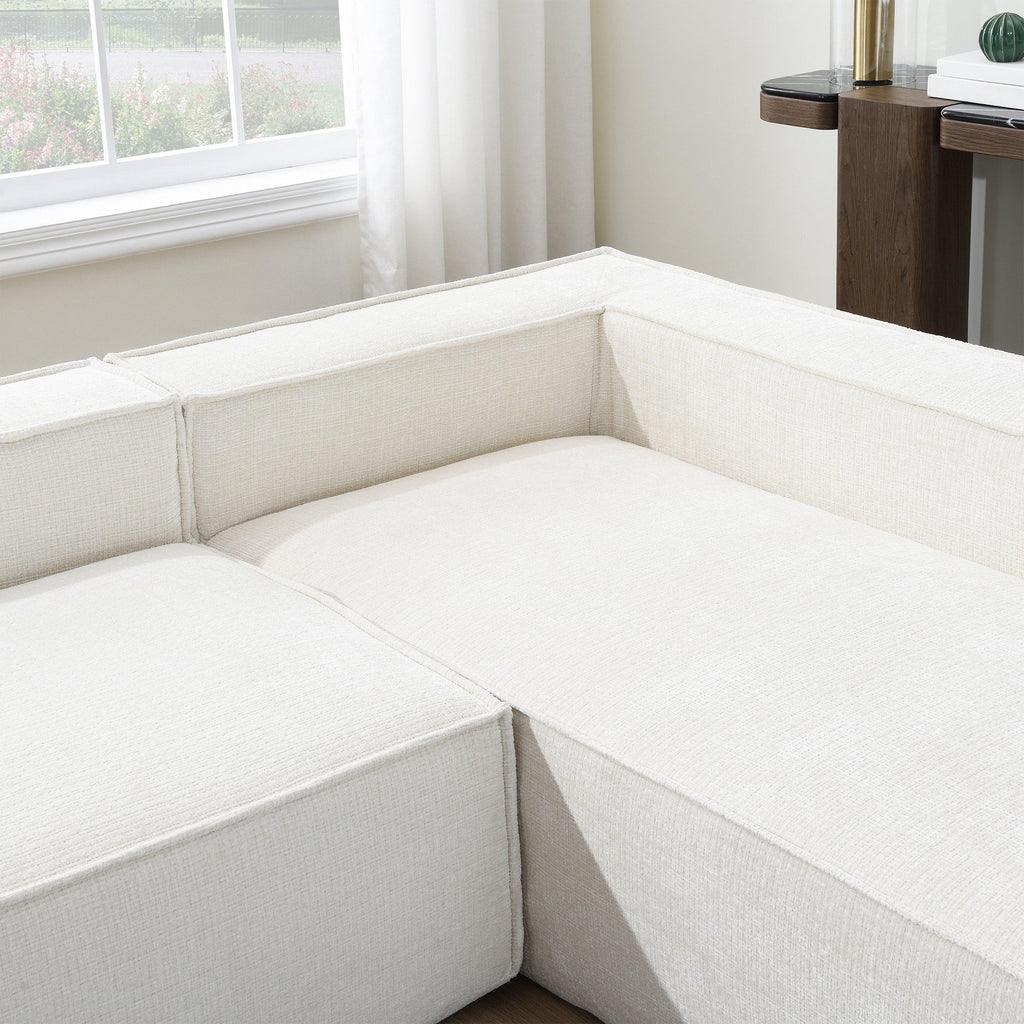 Detail of corner section of modular chenille sofa, highlighting deep seating and wrinkle-resistant fabric texture.