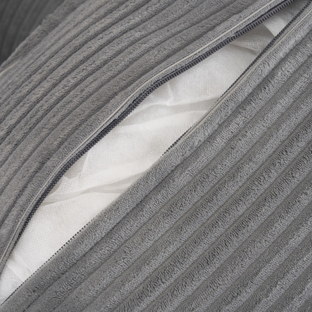 Zippered cushion cover on modular sofa revealing inner padding, designed for easy cleaning and long-lasting comfort.