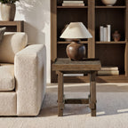 Square, medium-dark brown reclaimed elm trestle side table with rustic wood grain and a sturdy four-legged base.