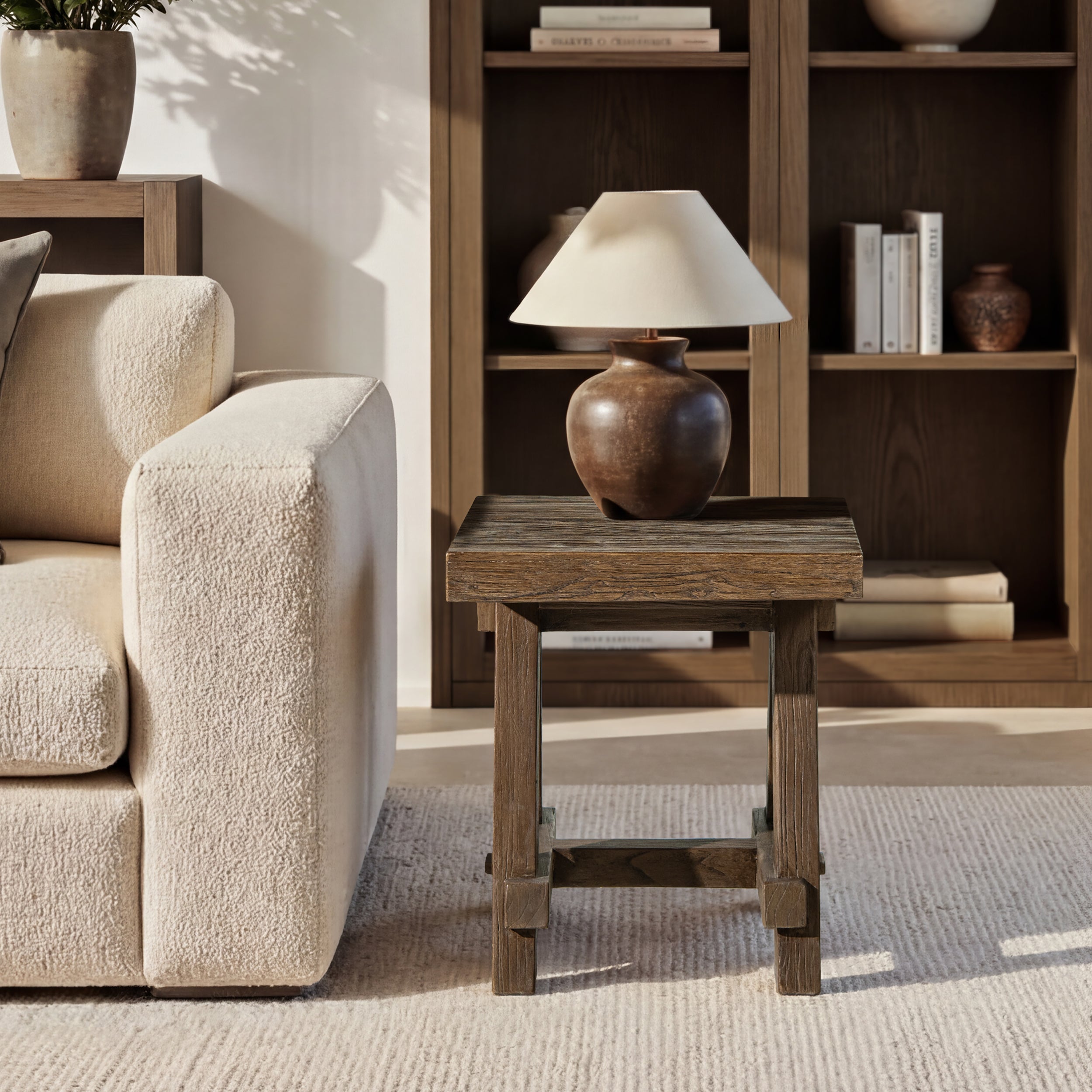 Square, medium-dark brown reclaimed elm trestle side table with rustic wood grain and a sturdy four-legged base.