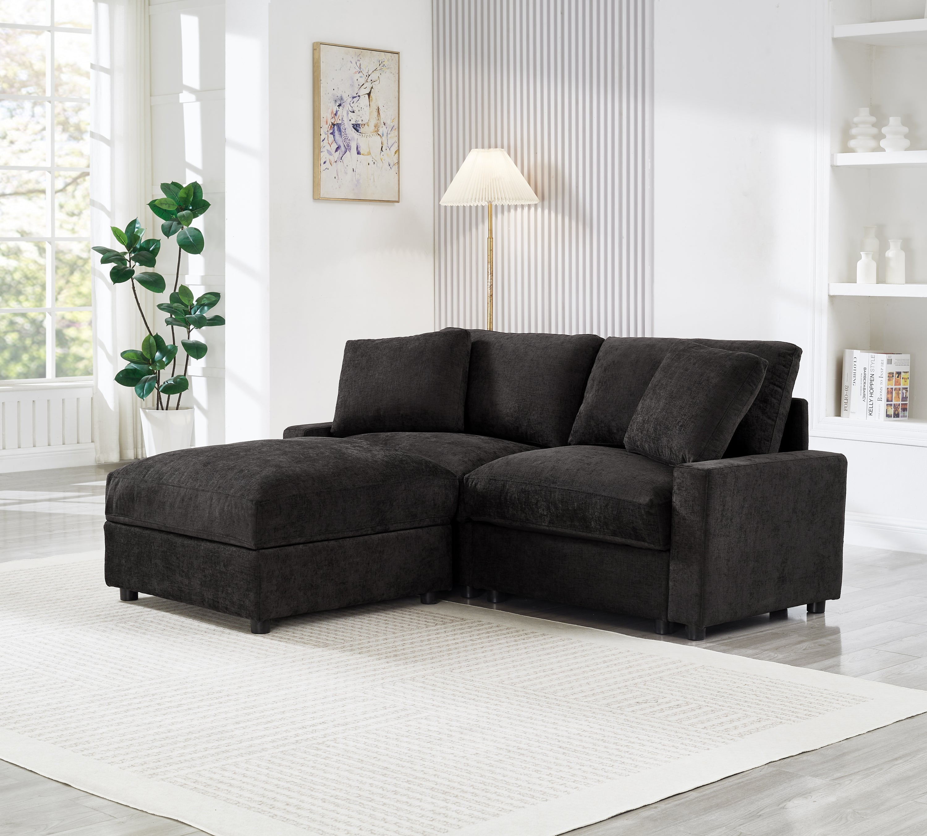 Modern black modular L-shaped sectional sofa in polyester fabric with plush cushions and a matching storage ottoman.
