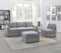 Plush, granite-colored modular sectional set with an ottoman, featuring textured fabric in a contemporary living room.