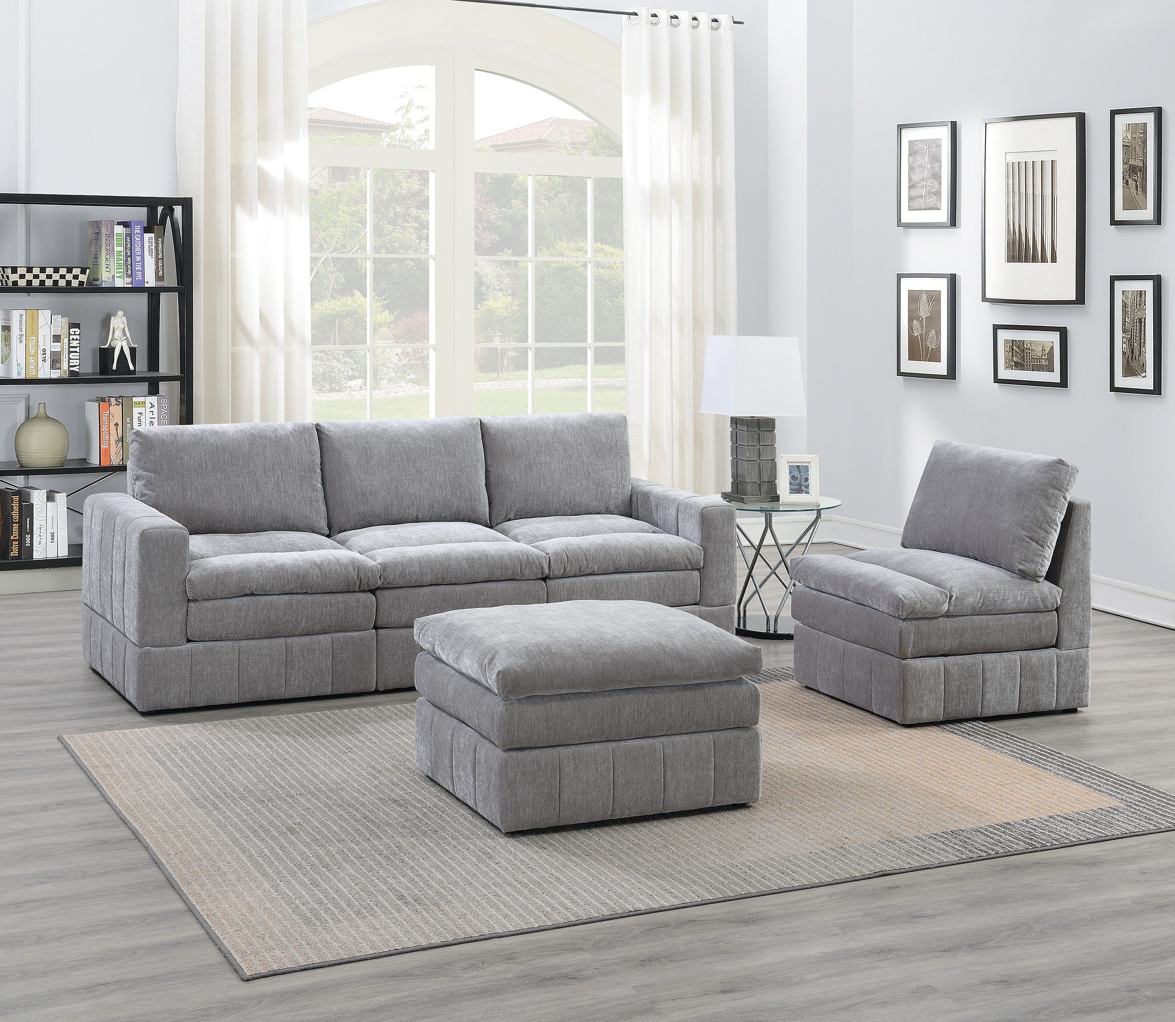 Plush, granite-colored modular sectional set with an ottoman, featuring textured fabric in a contemporary living room.