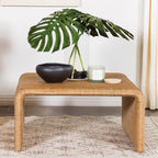 Natural Square Woven Rattan Coffee Table styled with decor, showcasing its spacious top and natural finish for modern interiors.