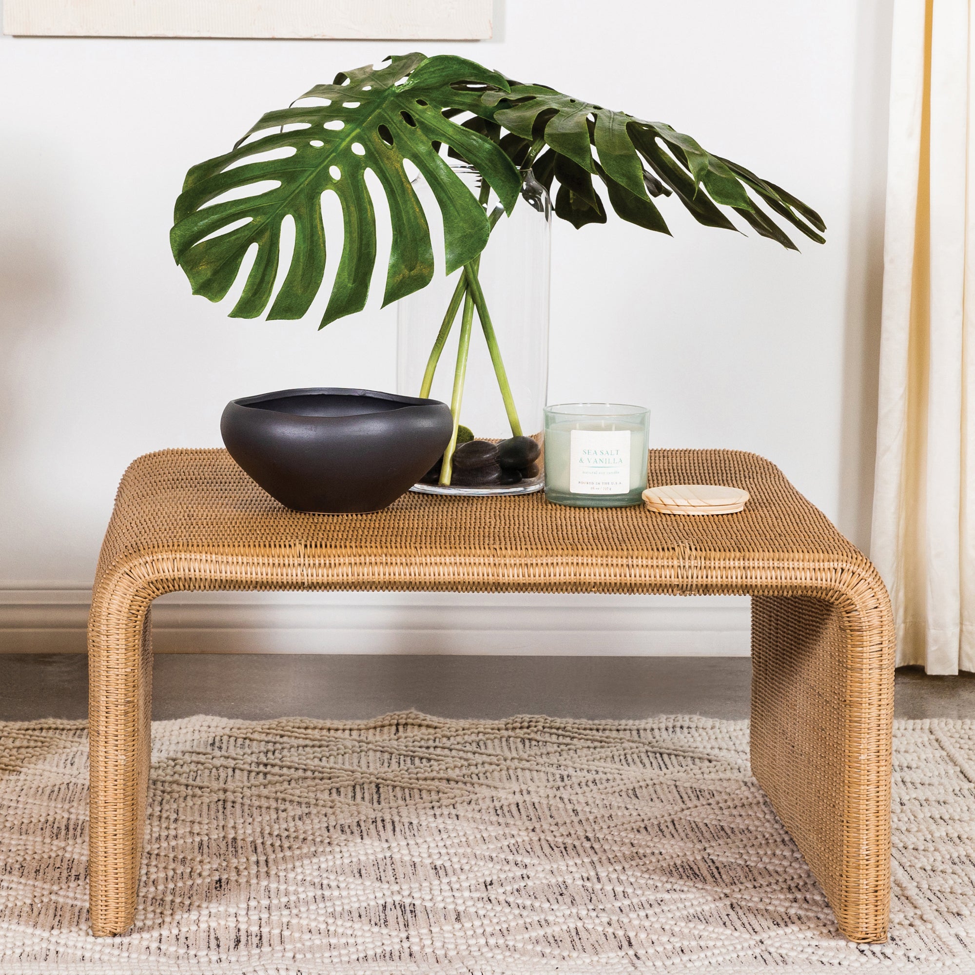 Natural Square Woven Rattan Coffee Table styled with decor, showcasing its spacious top and natural finish for modern interiors.
