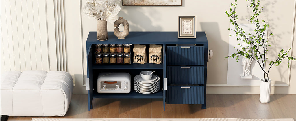 Interior view of navy sideboard with open doors and drawers, displaying ample storage for jars, dishes, and pantry items.