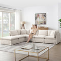 Modular sectional sofa with ottoman in a bright living room, offering spacious seating and plush cushions for versatile comfort.