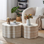 Two modern, scalloped, faux-travertine nesting coffee tables with beige marble-like textures on a textured rug.