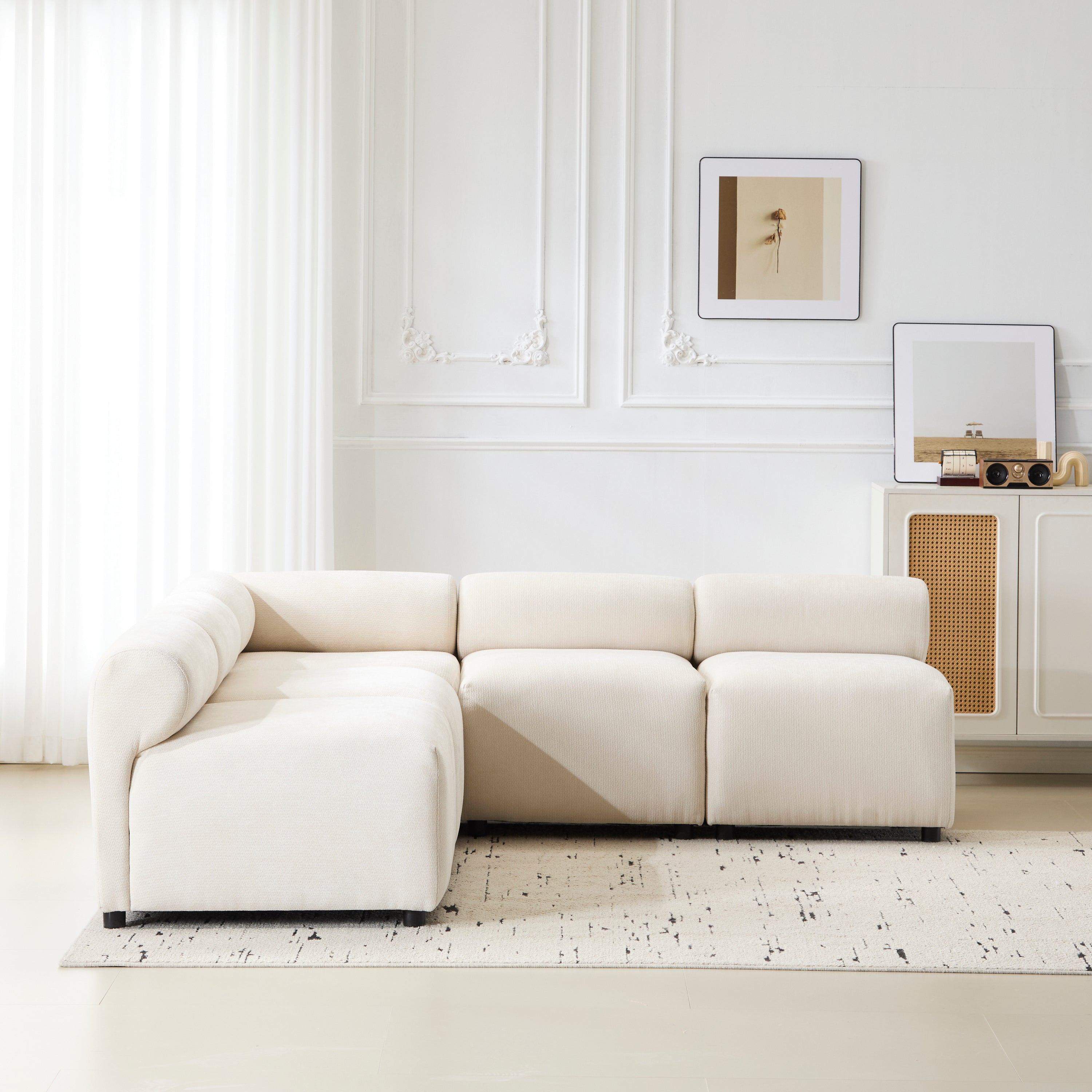 L-shaped configuration of Evelyn 83'' modular chenille sectional sofa placed in a bright, elegant living space.