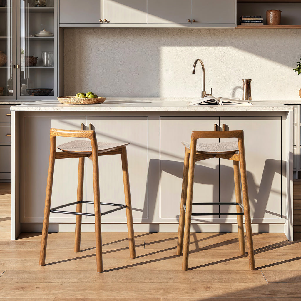 Pair of Sven 30' dark brown modern low back wood barstools in a bright kitchen with light cabinetry and wood flooring.