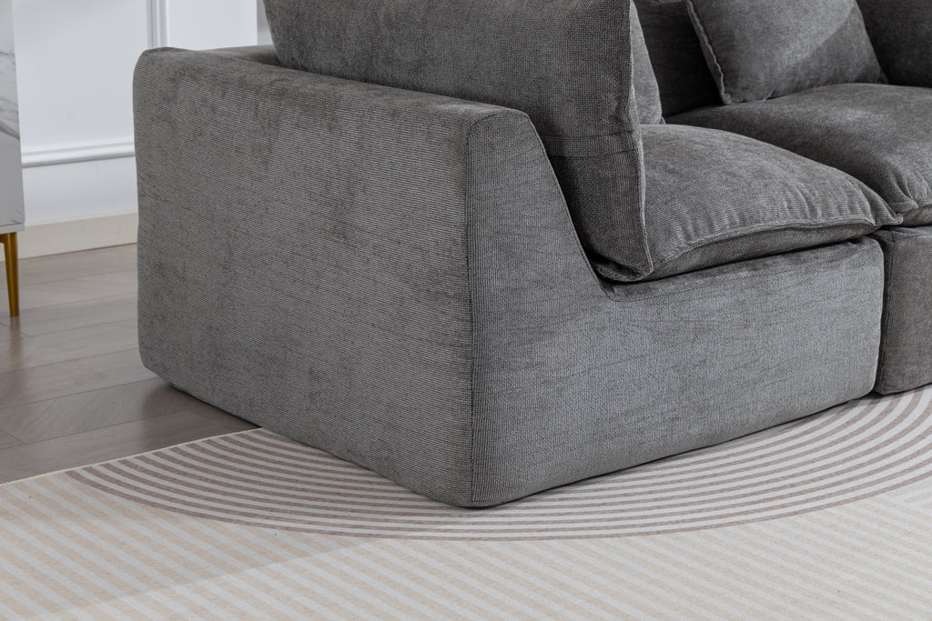 Close-up of Cloud Couch Oversized Modular Sectional Sofa in antique grey velvet, showcasing plush armrest and deep seat design for luxurious comfort.