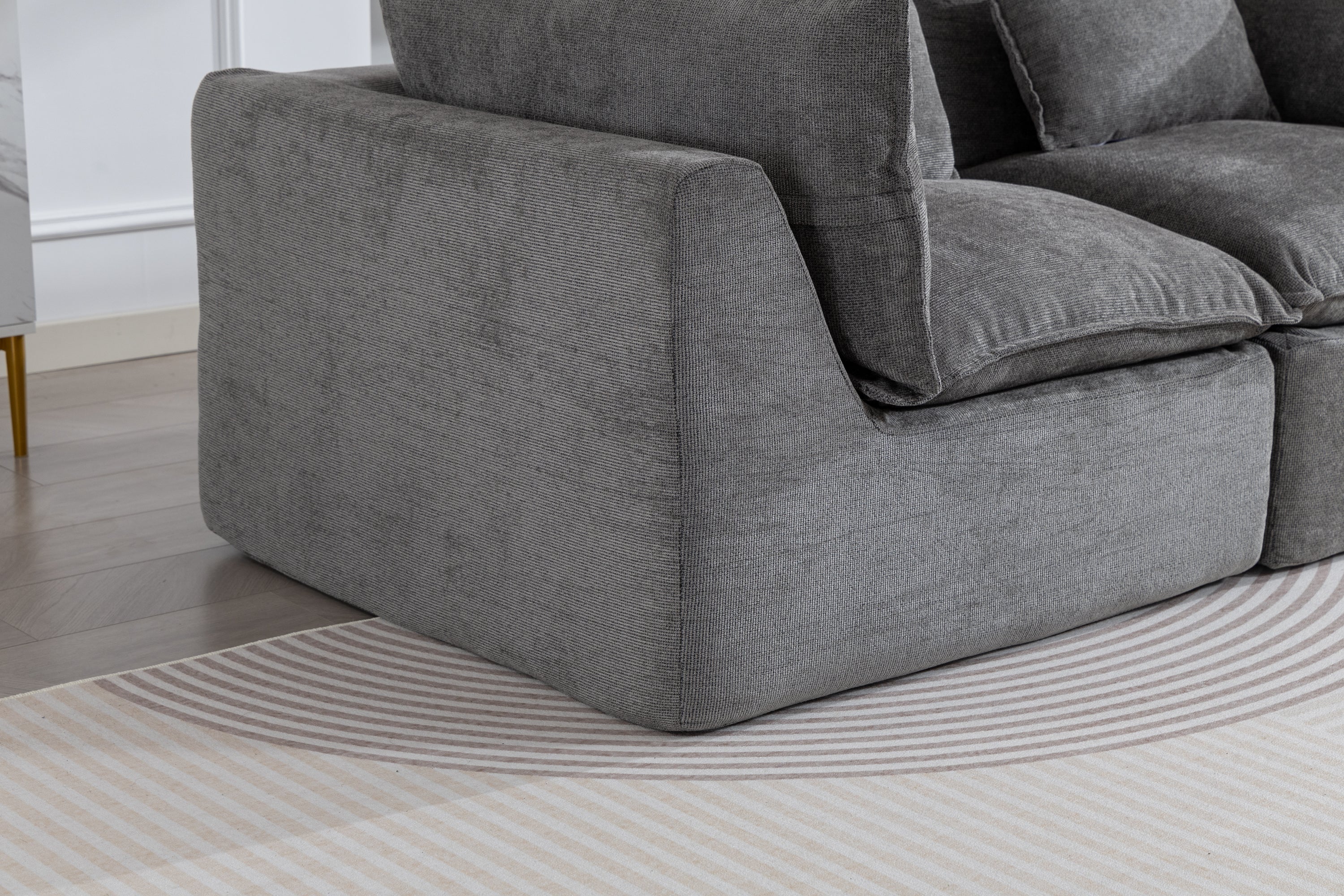 Close-up of Cloud Couch Oversized Modular Sectional Sofa in antique grey velvet, showcasing plush armrest and deep seat design for luxurious comfort.